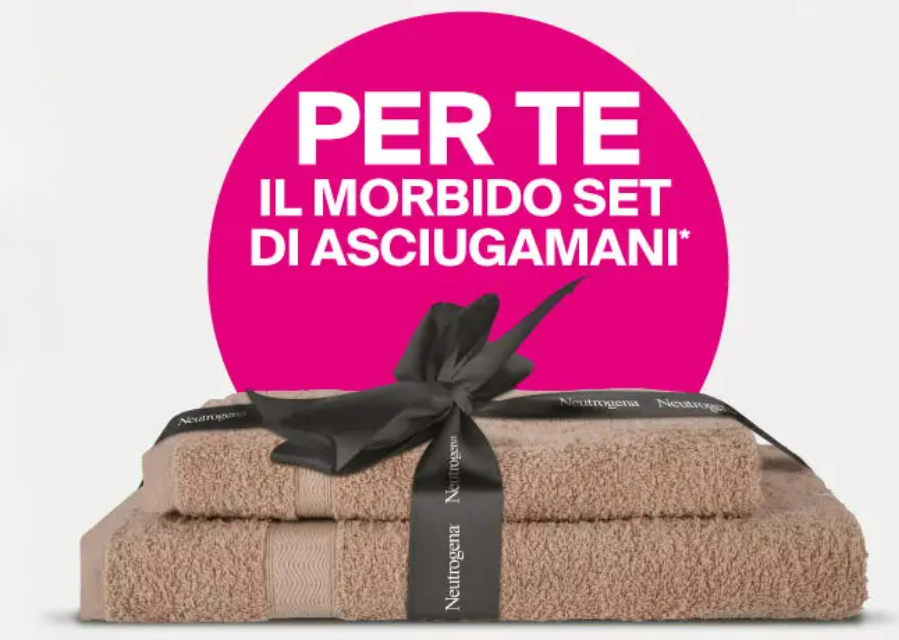 Set di asciugamani Neutrogena avvolto con un nastro nero, posizionato su uno sfondo bianco, con un cerchio rosa e testo che dice 'PER TE IL MORBIDO SET DI ASCIUGAMANI*'.